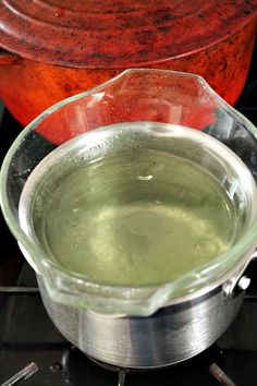 a glass bowl filled with liquid sitting on top of an oven