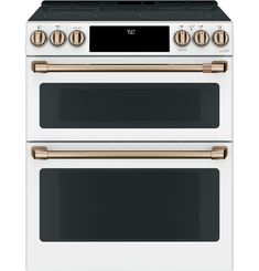 two white ovens side by side with gold knobs on the top and bottom