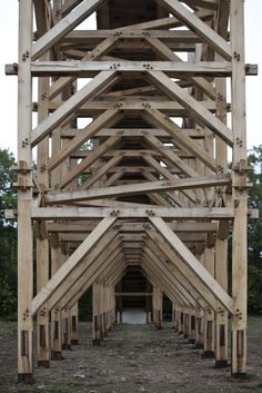 the underside of a wooden structure with multiple beams on each side and one at the top