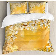 an image of a bed with yellow and white flowers on the comforter cover set