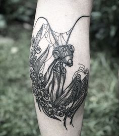 a black and white tattoo on the leg of a person with an octopus in it