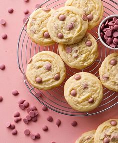 chocolate chip cookies on a wire rack with pink sprinkles next to it