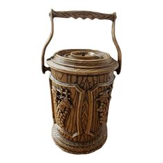 an old wooden bucket with handles and carvings on the sides, isolated against a white background