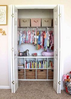 an organized closet with clothes and toys in baskets on the bottom shelf, along with other items