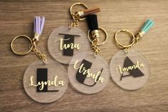 three acrylic keychains with the words tun, lynda, usa and canada written on them