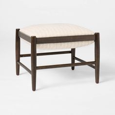 a wooden bench with a white upholstered cushion