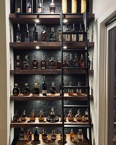 the shelves are filled with bottles of liquor