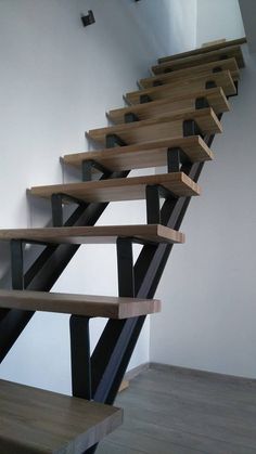 a set of wooden stairs with metal railings