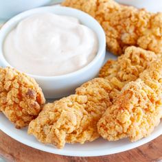 fried chicken rings on a plate with ranch dip and tomatoes in the bowl behind them