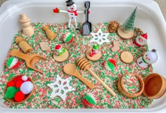 a tray filled with wooden spoons and toys