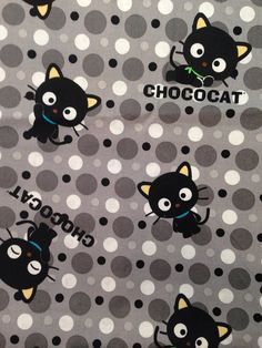 black cats and polka dots on grey fabric with white circles in the background that says chococat