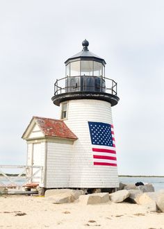 a lighthouse with an american flag painted on it