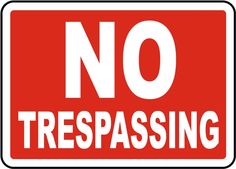 a red and white sign that says no trespassing