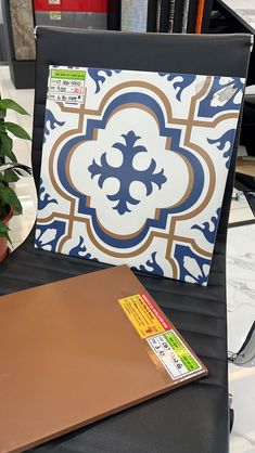 a laptop computer sitting on top of a desk next to a potted plant