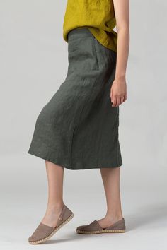 READY TO SHIP - Minimalist seasonless A-line linen skirt featuring an elasticated back waist for increased comfort and flattering fit and midi length which makes it easy to style with any top shape.  Made of pure washed European linen for a perfectly soft feel and naturally wrinkled look.  FIT The A-Line Skirt has a relaxed fit and sits slightly below the waistline. The intended positive ease around the hips is 8-12 cm/3.1-4.7".  To choose the right size, check out our body and garments measurem Versatile Lined Skirt, Versatile Solid Color Midi Skirt, Spring Maxi Skirt In Solid Color, Versatile Green Relaxed Fit Skirt, Lined Relaxed Knee-length Skirt, Lined Knee-length Relaxed Skirt, Solid Color Midi Pencil Skirt With Pockets, Solid Midi Pencil Skirt With Pockets, Solid Linen Relaxed Skirt