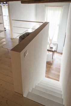 an empty room with stairs leading up to the second floor