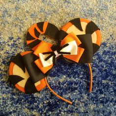 an orange and black hair bow on carpet