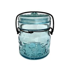 a blue glass jar with a metal handle