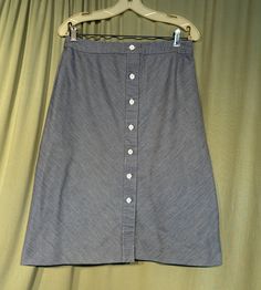 "This is a cute vintage A line skirt, from the 70s. Labeled Schrader Sport & tagged a size 16. Waist measures 30\", please see measurements.  Made of cotton denim in a blue & white ticking stripe. It is an A-line skirt, that reaches below the knee. Buttons all the way down the front with white plastic buttons. The skirt is in very good condition. No soil or stains.  No damage. No fading. Sweet! Measurements were taken with the garment lying flat. If you have never worn vintage before, please mea Vintage Skirt Bottoms With Button Closure, Vintage Cotton Denim Skirt, Vintage Skirt With Button Closure, Retro Fitted Skirt With Buttons, Vintage Skirt With Button Closure For Summer, Retro Spring Bottoms With Buttons, Retro Denim Skirt For Spring, Vintage Buttoned Denim Skirt For Spring, Vintage Skirt Bottoms With Buttons