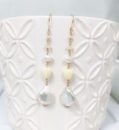 "Neutral and dainty Hawaiian style earrings featuring fresh water pearls , Ethiopian opal and pikake beads. Fresh water pearls are 12-14mm in size. Resin pikake beads are approximately 7-8 mm. Earrings length is approximately 2\" not including ear wires. Hand shaped 14k gold filled French ear wires. PLEASE NOTE: As you can see in the photos there are naturally occurring blemishes that give these pearls characters. These are stock photos so pearls are vary in shape and color." Dainty White Opal Earrings, White Pearl Charm Earrings, Delicate White Jewelry With Dangling Beads, White Dainty Jewelry With Dangling Beads, White Pearl Earrings With Dangling Beads As Gift, White Briolette Pearl Drop Earrings, White Opal Drop Earrings, Delicate White Briolette Earrings, Ethiopian Opal Earrings