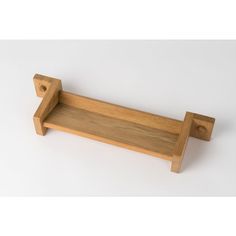 a wooden shelf with two hooks on it