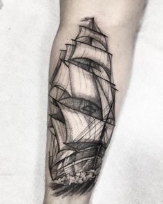 a black and white ship tattoo on the arm