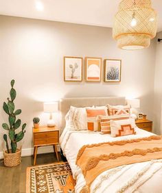 a bed with orange and white pillows in a bedroom