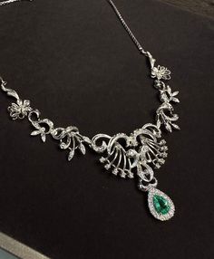 Elegant and exquisite, Victorian style necklace with diamonds in 18Kt white gold in symmetrical floral design, beautifully handcrafted. The center sits a sparkly, enchanting natural Colombian Emerald in pear cut, the emerald is 0.70 ct and has stunning luster, it is surrounded with a halo of natural brilliant white diamonds weight approx 0.2 ct. The necklace is a true beauty, ravishing and gleaming, the floral part was made with 9 hinged section, with millegrain setting details and dainty diamon Luxury White Gold Emerald Necklace With Diamond Accents, Luxury Emerald Necklace With Diamond Accents For Formal Events, Formal White Gold Emerald Necklace, Hand-set Emerald Pendant Necklace For Formal Occasions, Hand Set Emerald Pendant Necklace For Formal Occasions, Exquisite Diamond And Emerald Formal Necklace, Exquisite Emerald Necklace For Anniversary, Exquisite Diamond Emerald Necklace For Formal Occasions, Luxury White Gold Emerald Necklace With Brilliant Cut