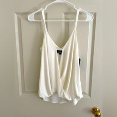 New With Tags- Lulu’s White Crossbody Camisole Top Size Medium I Love This Top But I’m Too Busty For It After Kids Camisole Tops With Built-in Bra For Date Night, Chic White Tops With Tank Straps, Chic White Tank Top, White Tank Top For Night Out, Elegant White Tank Top With Straps, White Sleeveless Top For Date Night, White Tank Top With Tank Straps For Night Out, White Casual Camisole For Night Out, Elegant White Top With Tank Straps