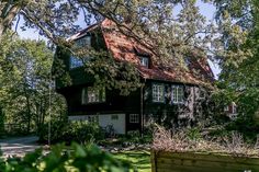 the house is surrounded by trees and greenery