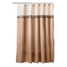 a tan and white shower curtain hanging on a rod