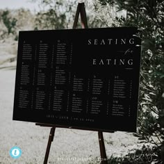 a seating sign in front of a tree with the words seating on it and an easel