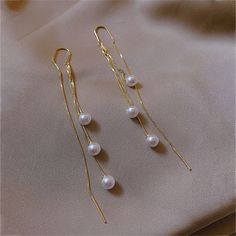 Bring some shine to your ears with this pair of 18k gold-plated threader earrings featuring pearls along a chain. 0.2" W x 4.05" L 18k gold-plated copper / pearl Tassel Earring, Copper Pearl, Pearl Strand, Gold Bride Jewelry, Gold Earrings Designs, Flower Hair Accessories, Pearl Strands, Threader Earrings, Bride Jewellery