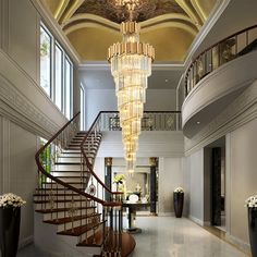 an elegant foyer with chandelier and marble floors