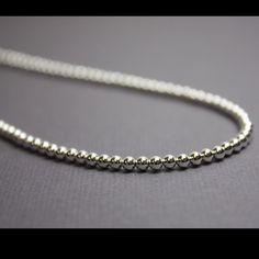 A Pretty Glistening Sterling Silver Bead Necklace. This Necklace Features A Single Strand Of Small 3mm Sterling Silver Beads. The Necklace Could Be Layered With Others Or Worn Alone. Sparkly, Small And Delicate, It Would Make A Wonderful Addition To Any Wardrobe. The Single Strand Necklace Will Be Made To Order And Is Available In 13" To 24” Inches Lengths. I Hand String These Sterling Silver Beads On Beading Wire And Finish Them With A Sterling Silver Lobster Clasp And Ring. This Listing Price Silver Single Strand Everyday Beaded Necklace, Everyday Beaded Necklaces With Round Ball Chain, Everyday Necklace With Spacer And Round Beads, Everyday Round Beads Necklace With Spacer Beads, Classic Silver Beaded Necklaces As Gift, Everyday Silver Beaded Necklaces, Minimalist Silver Beaded Necklace, Necklace String, Charm Holder Necklace