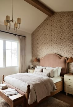 a bedroom with a bed, dressers and lamps on the side of the room