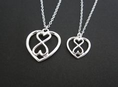 This beautiful sterling silver double heart pendant necklace makes a great gift for everyone. The matching large heart pendant necklace is also available. You can purchase the double heart pendant necklace separately, or purchase them as matching mother and daughter(s) necklaces, they will be a great family keepsake that last forever.♥ Sterling silver chain & clasp♥ 22x23.9mm sterling silver infinity heart charm♥ 15x16mm sterling silver infinity heart charm♥ Solid sterling silver components♥ Small Heart Necklace, Eternity Necklace, Mother Daughter Jewelry, Bride Necklace, Mother Daughter Necklace, Infinity Pendant, Sterling Silver Heart Pendant, Infinity Heart, Daughter Necklace