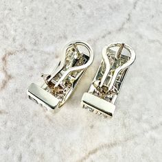 Fine pair of vintage 14 karat yellow gold diamond huggie earrings. They are channel set with 2 rows of round diamonds weighing approximately 2.75 carats (32 stones). The diamonds are F-G in color and VS-SI in clarity. Stamped 14k. Weighs 7.49 grams. L: 0.72 inch (1.85 cm). W: 7.57 mm. Closure: Omega Backs/Clip-On. Birthstone: April. Condition: Excellent. Faint wear throughout metal. - 14 day return policy, no questions asked. - Free insured shipping in the US. - International shipping available. Diamond White Gold Clip-on Earrings For Anniversary, White Gold Clip-on Earrings With Diamond Accents For Anniversary, Anniversary White Gold Clip-on Earrings With Diamond Accents, White Gold Clip-on Earrings For Anniversary, Silver Diamond Clip-on Earrings, White Gold Cubic Zirconia Clip-on Diamond Earrings, Silver Clip-on Diamond Earrings, White Gold Clip-on Diamond Earrings With Cubic Zirconia, Luxury Clip-on Huggie Earrings For Anniversary