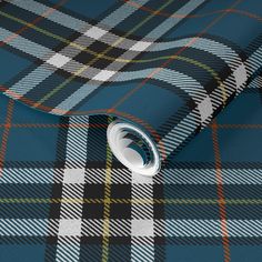 a blue tartan plaid wallpaper with a white circle on the top and bottom