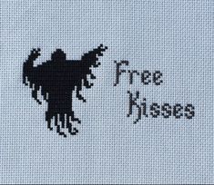 a cross stitch pattern with the words free kisses written in black on a white background