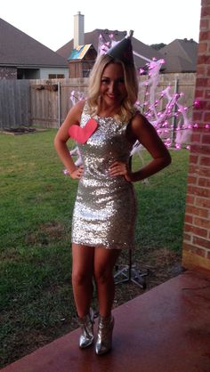 a woman in a silver dress posing for the camera