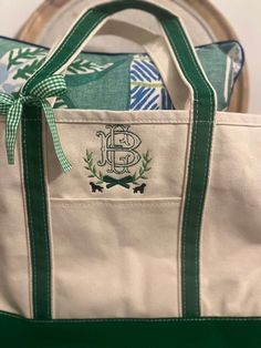 a canvas tote bag with the monogrammed initials and green trimmings