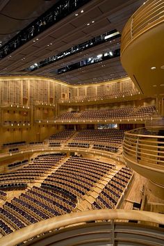 an empty auditorium with rows of seats and lights on the ceiling is seen in this image