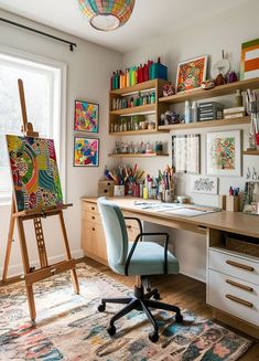 a desk with a chair and an easel on it in front of a window