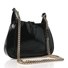 This is an authentic GUCCI Crinkled Patent Mini Jackie Notte Bag in Black. This stylish hobo is crafted of luxuriously crinkled patent leather in black. The bag features a polished gold chain link shoulder strap with a polished gold piston closure. This opens to a red leather interior with pockets. Leather Interior, Chain Link, Gold Chain, Red Leather, Gold Chains, Patent Leather, Shoulder Strap, Gucci, Chain