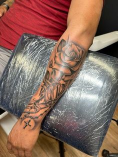 Red Ink Arm Tattoos Men, Middle Forearm Tattoo, Cross And Roses Tattoo For Men, Forearm Rose Tattoo For Men, Godly Tattoos For Men Sleeve, Top Forearm Tattoo For Men, Rose Tattoo Men Forearm, Forearm Half Sleeve Tattoos, Forarms Tattoo Designs Men