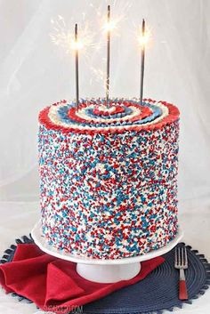 a red, white and blue cake with sparklers on top is shown in an instagram