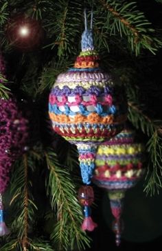 three knitted ornaments hanging from a christmas tree