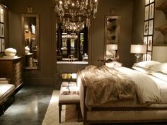 a bedroom with a chandelier hanging from the ceiling and a bed in it