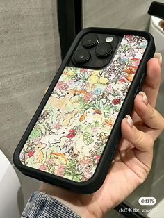 a person holding up an iphone case with flowers on it